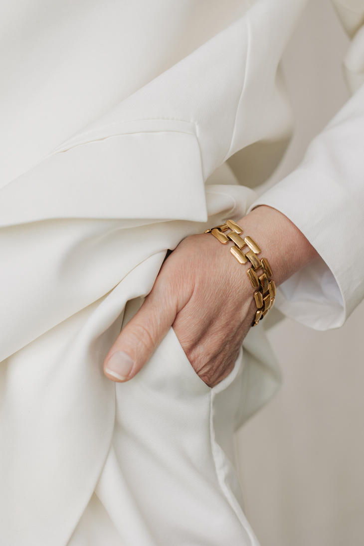 Woman in White Outfit and Gold Bracelet